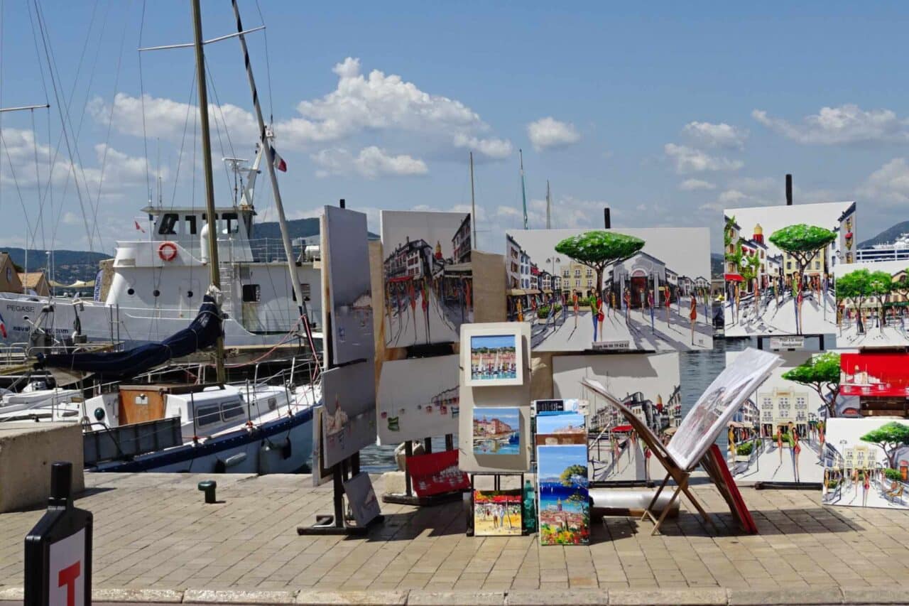 Noch heute verkaufen Künstler:innen ihre Werke auf der Promenade entlang des Yachthafens.